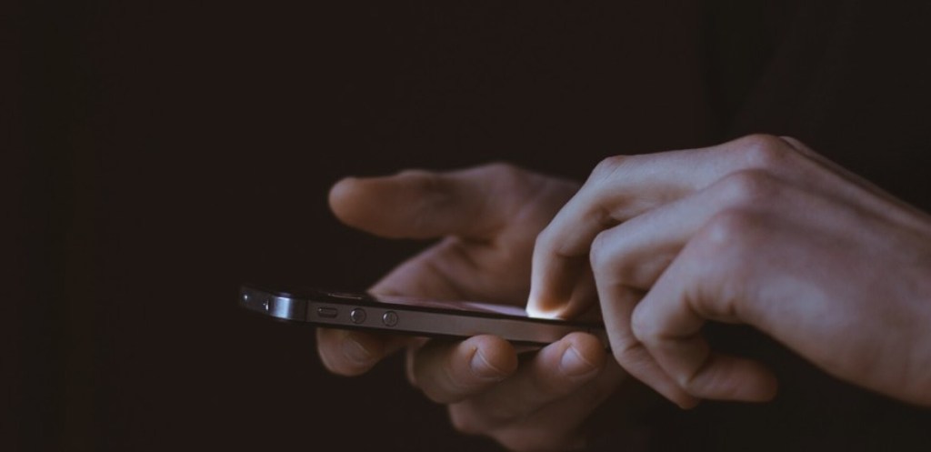 User tapping on mobile phone